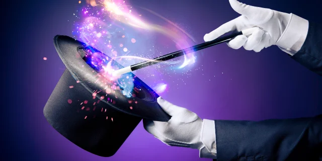 Magician hand with magic wand and hat