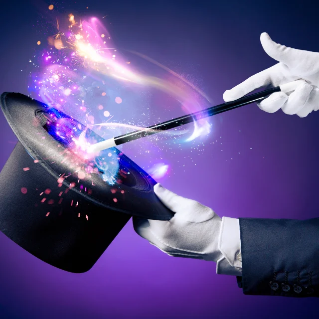 Magician hand with magic wand and hat